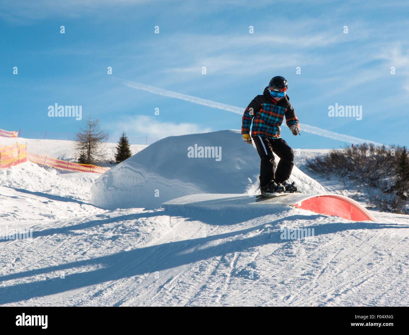 freestyle snowboarder with helmet in snowpark Stock Photo Alamy