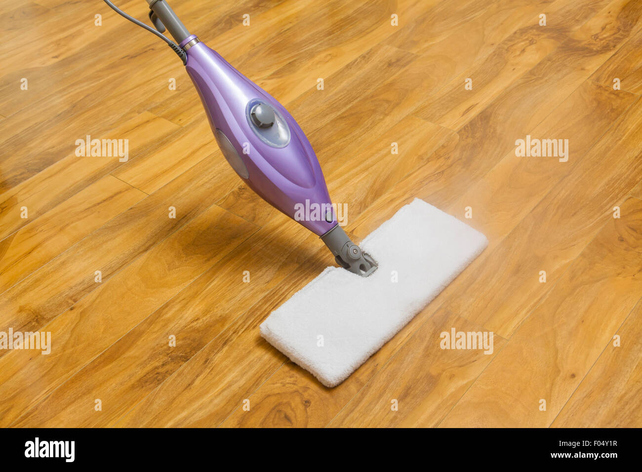 Using a steam mop Stock Photo