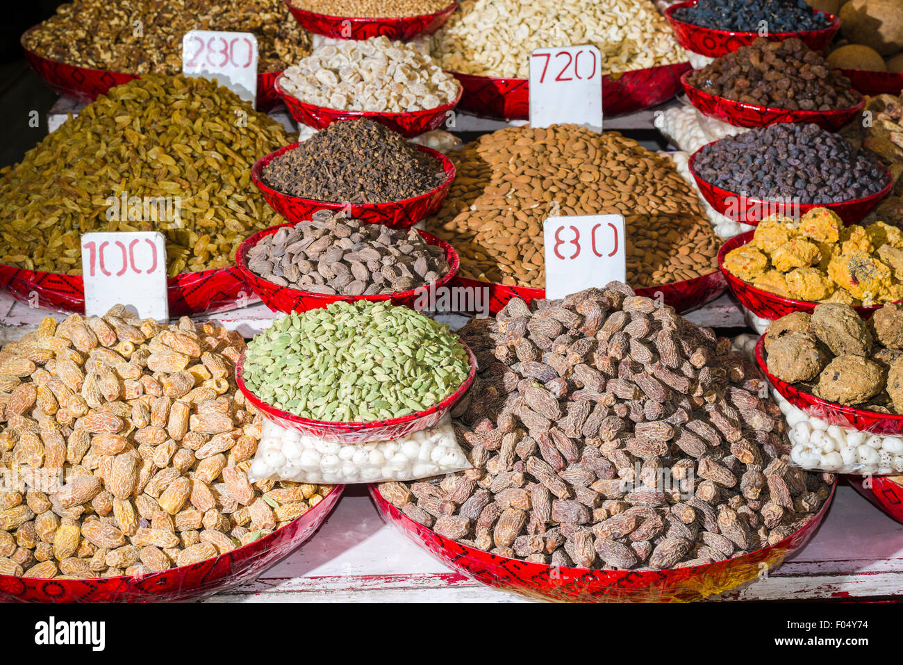 Dates, walnuts, raisins, cloves and cardamon are displayed in bowls in