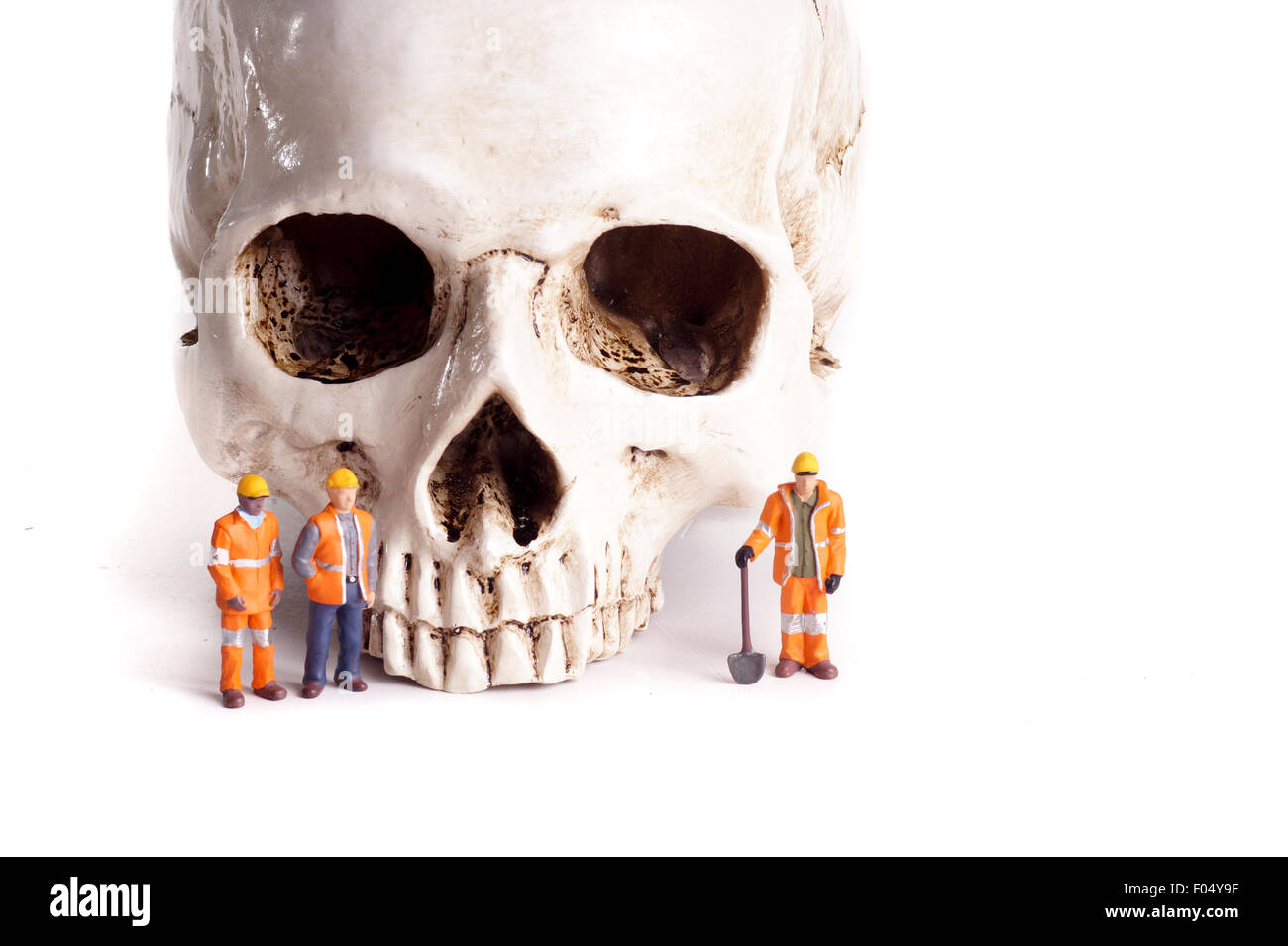 Skull and small workers, work accidents , dangerous work, take care of yourself Stock Photo