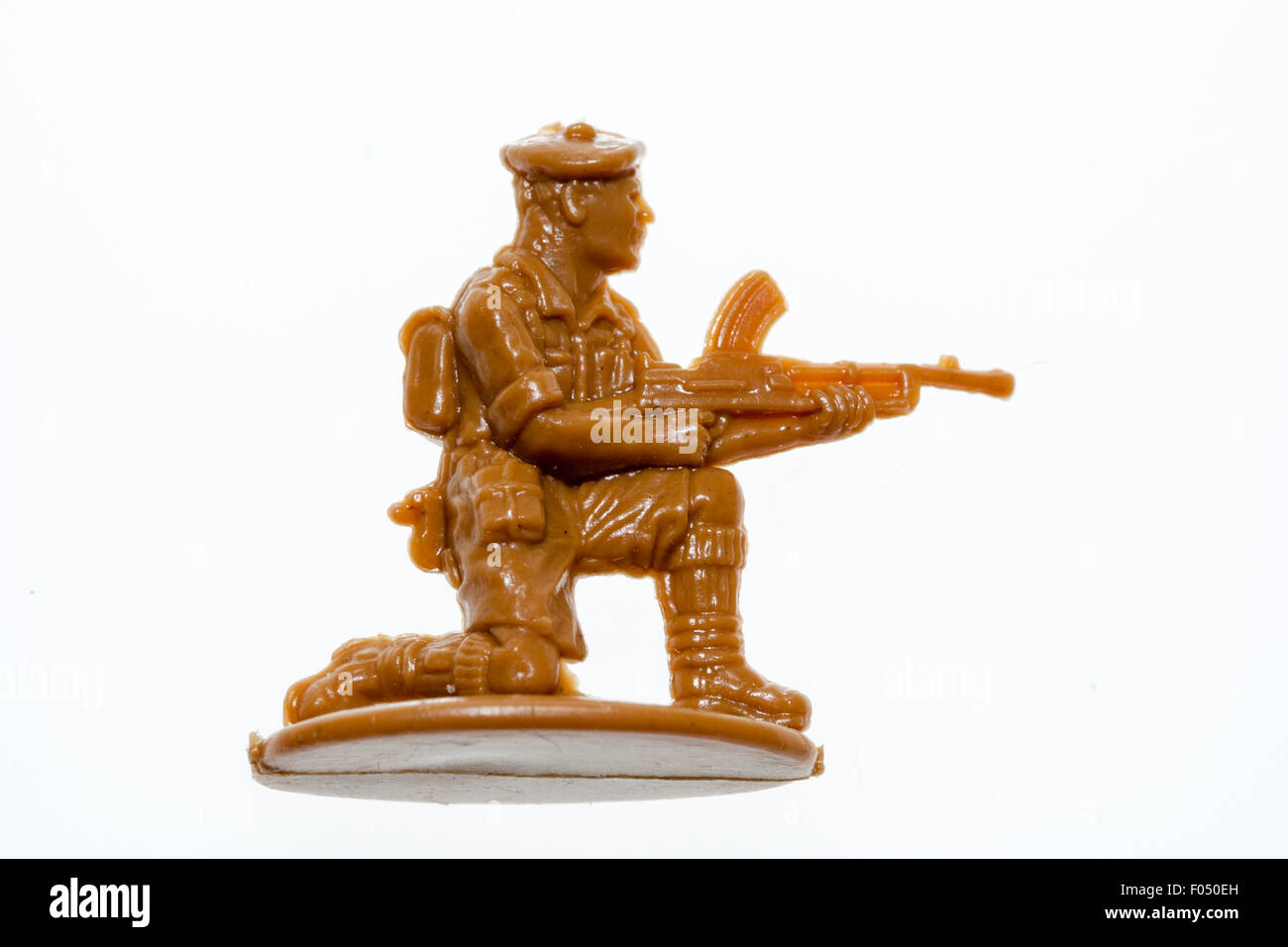 Matchbox HO/00 scale model toy figure. 8th Army world war two soldier kneeling down firing a Bren gun against plain white background. Stock Photo