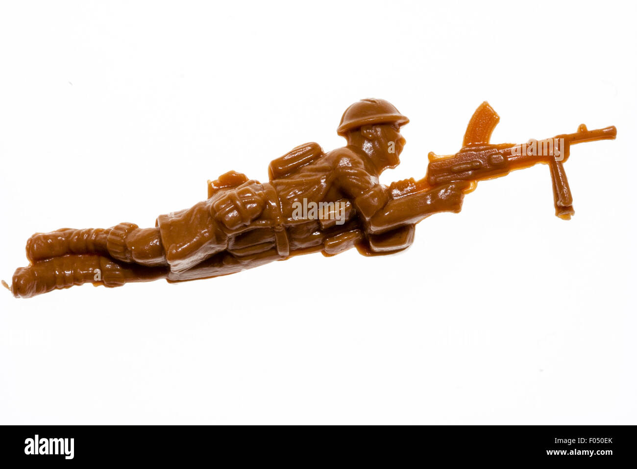Matchbox HO/00 scale model toy figure. 8th Army world war two soldier laying down firing Bern gun. Figure on plain white background. Stock Photo