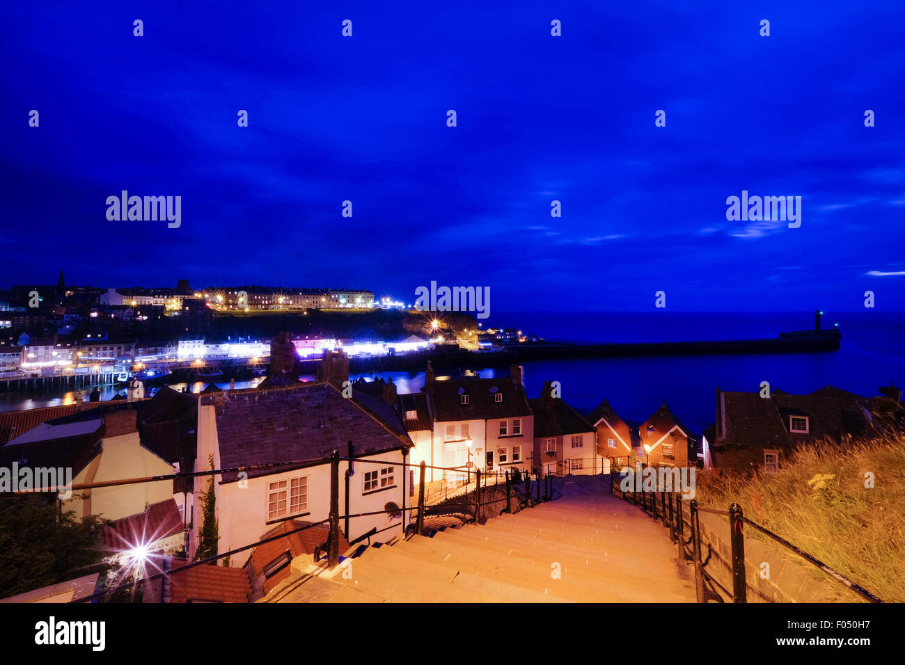 View from the top of the top of the 199 steps of St Mary the Virgin Church, looking down over Whitby at night Stock Photo