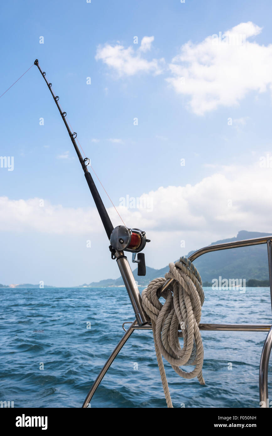 Sailing Rod Fishing rod and reel on a sailing yacht. Vertical shot Stock Photo - Alamy