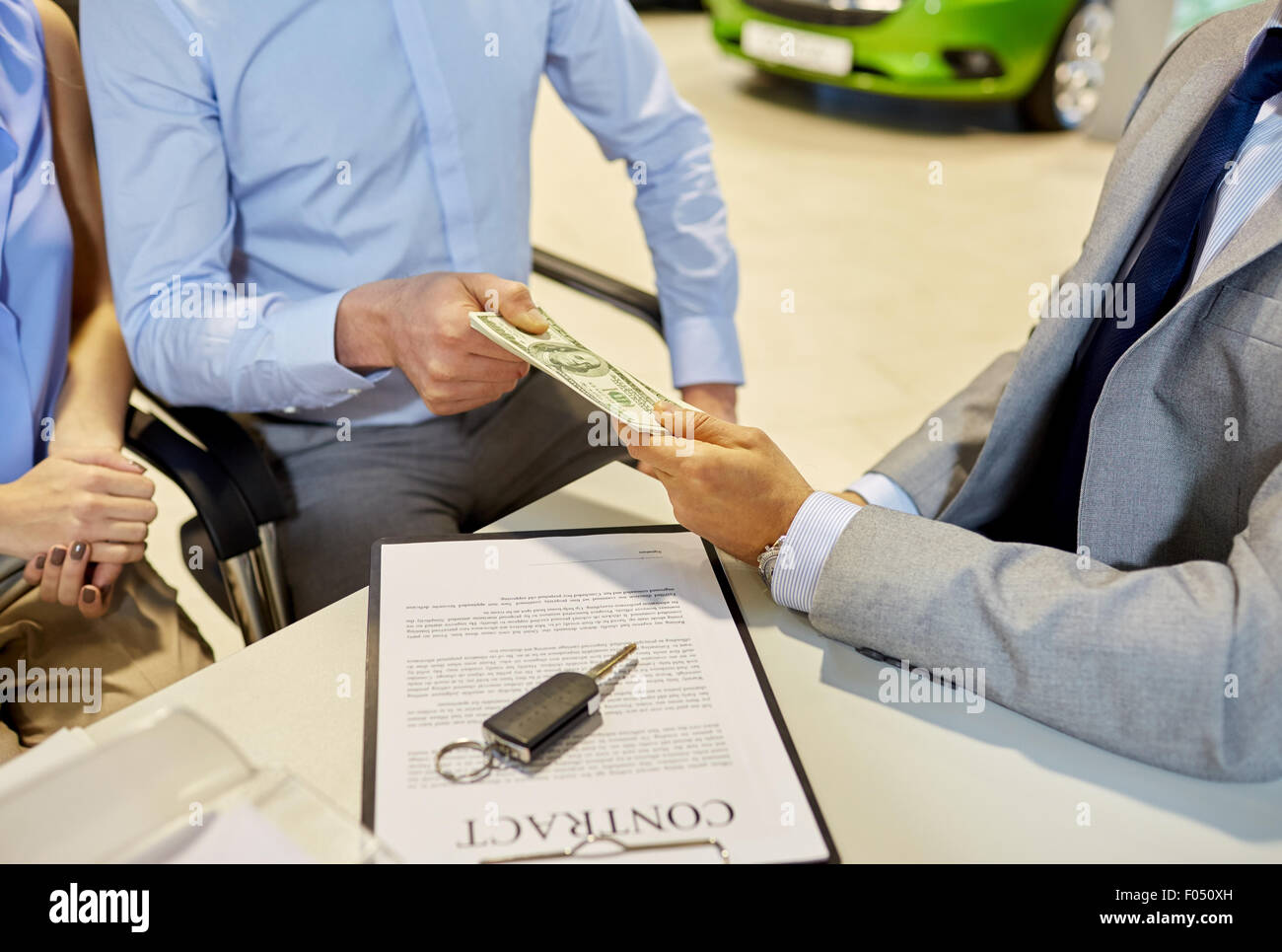 customers giving money to car dealer in auto salon Stock Photo - Alamy