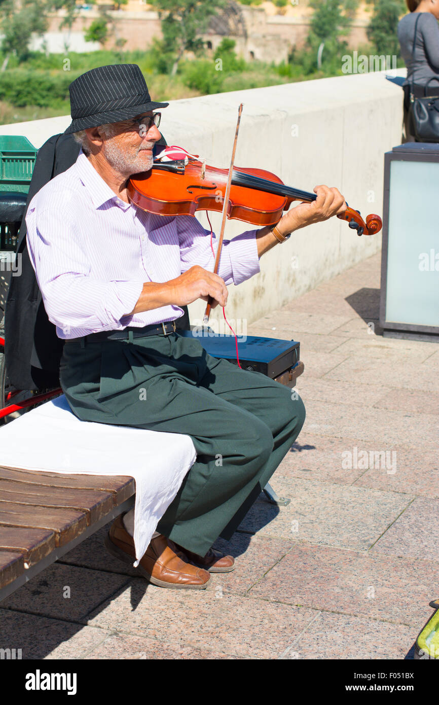 A musician paying the violin in Cordoba or Córdoba, Spain Stock Photo