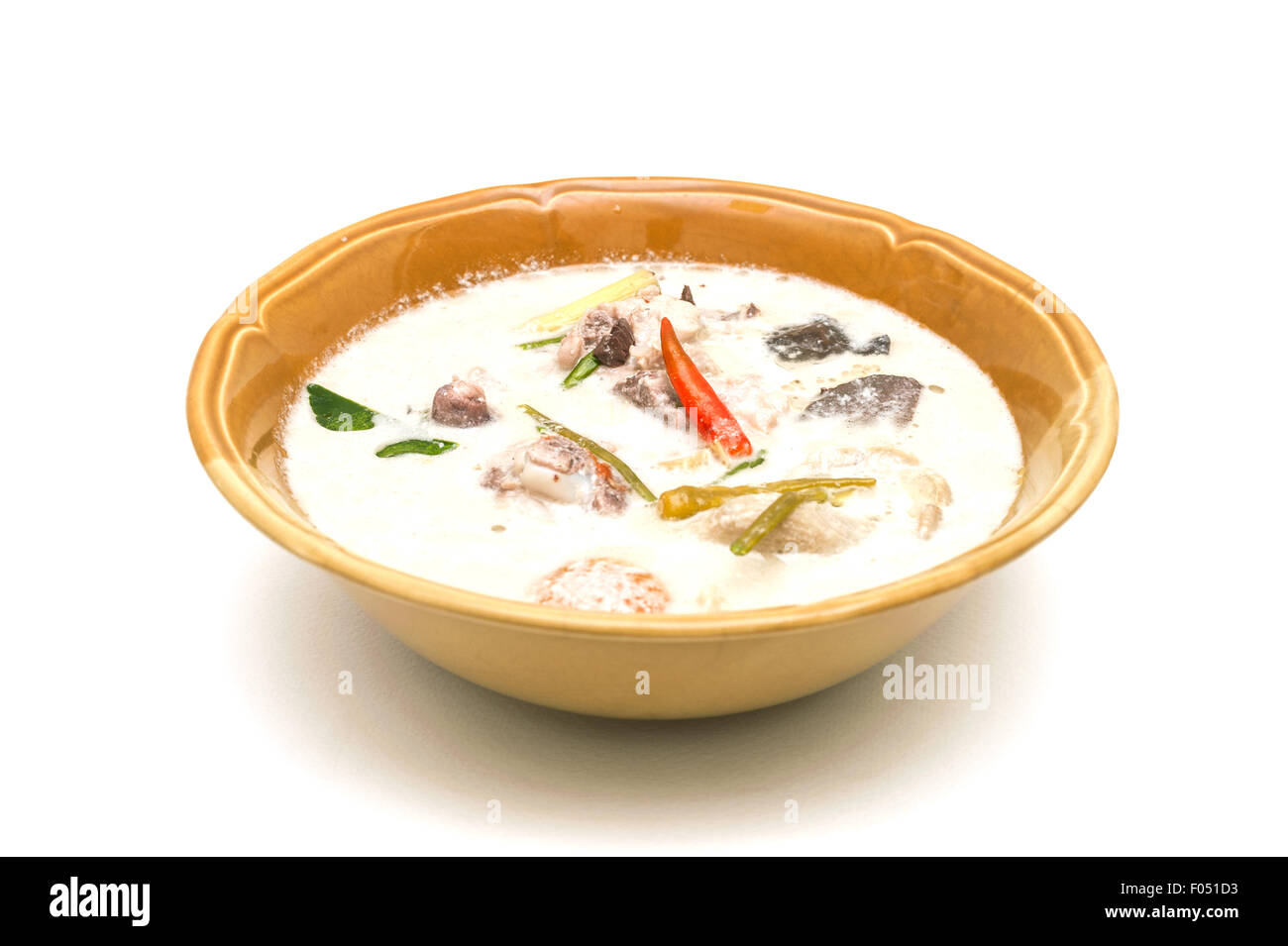 Soup made from coconut milk and vegetables on white background Stock Photo