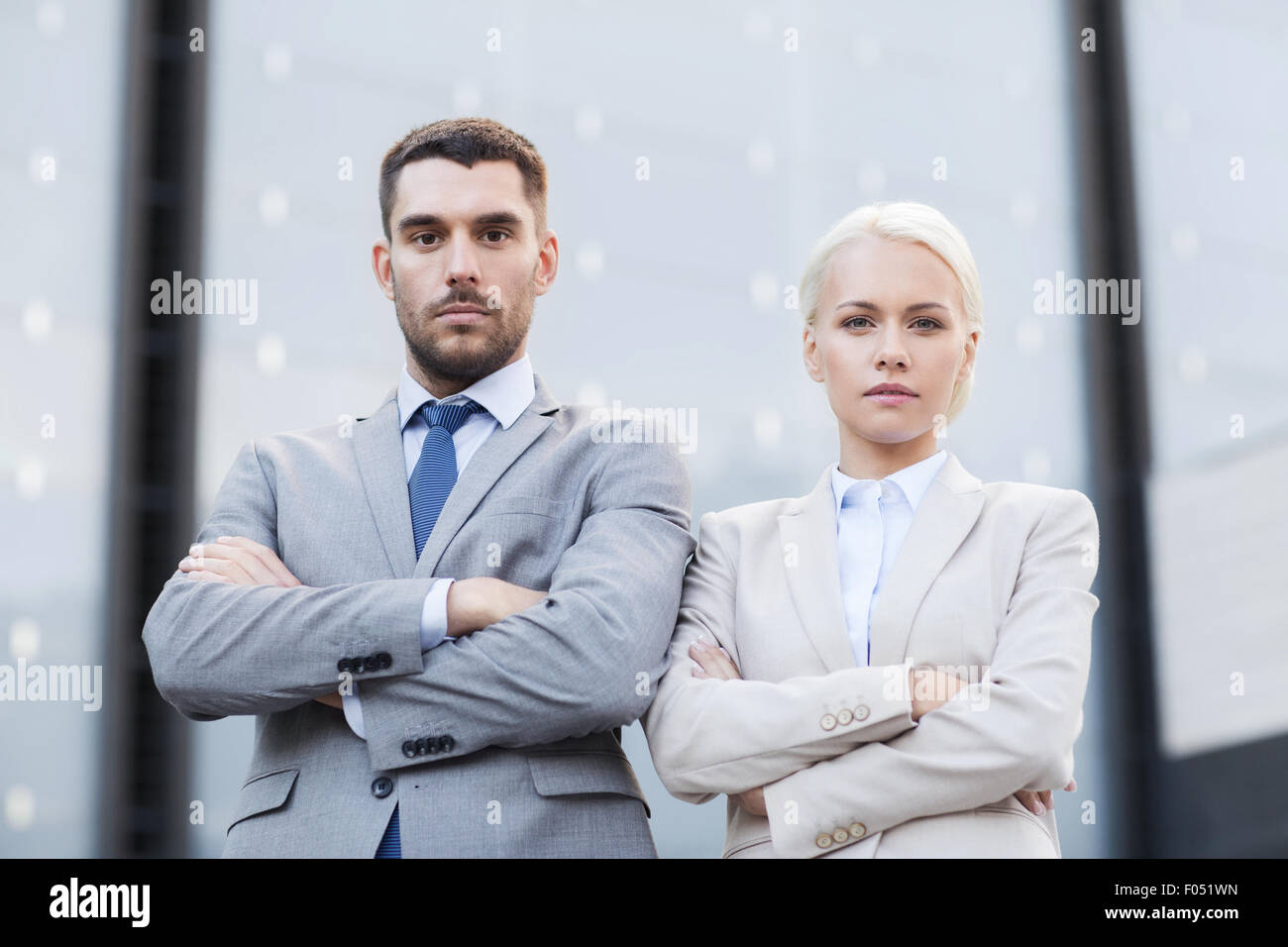 serious businessmen standing over office building Stock Photo - Alamy