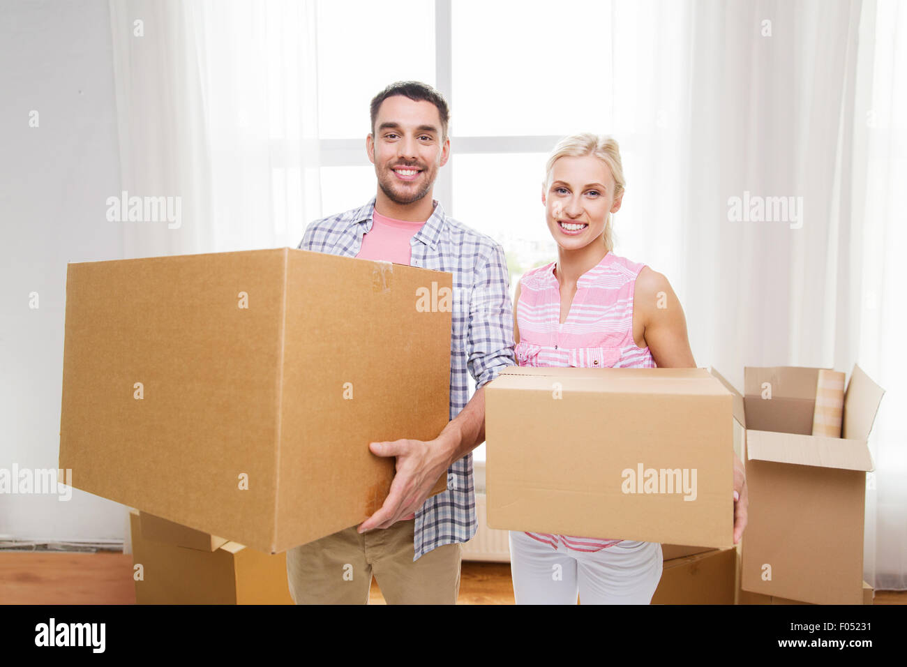 couple with big cardboard boxes moving to new home Stock Photo - Alamy