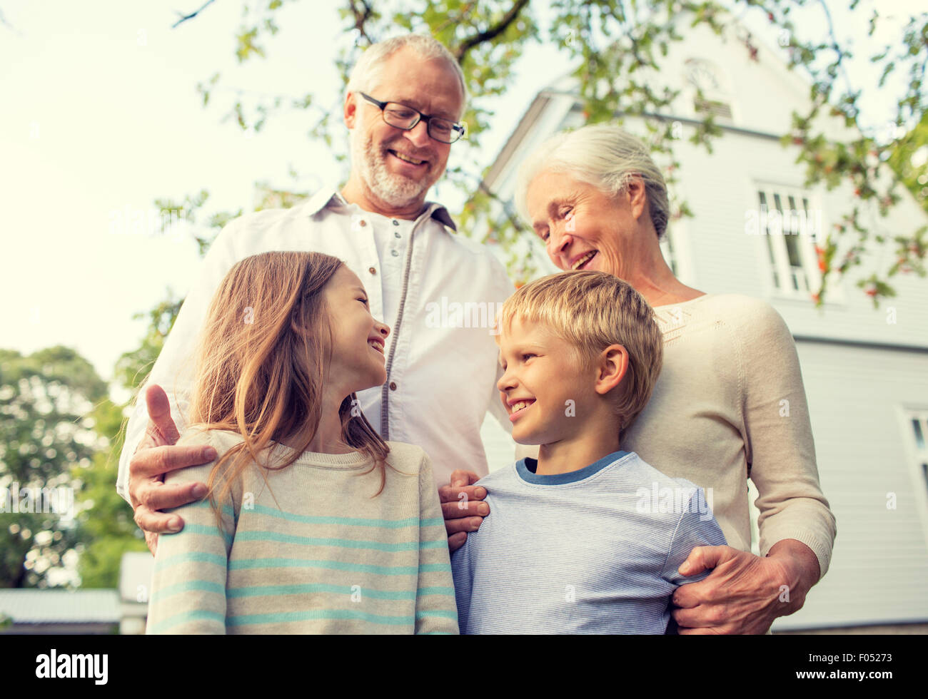happy family in front of house outdoors Stock Photo - Alamy