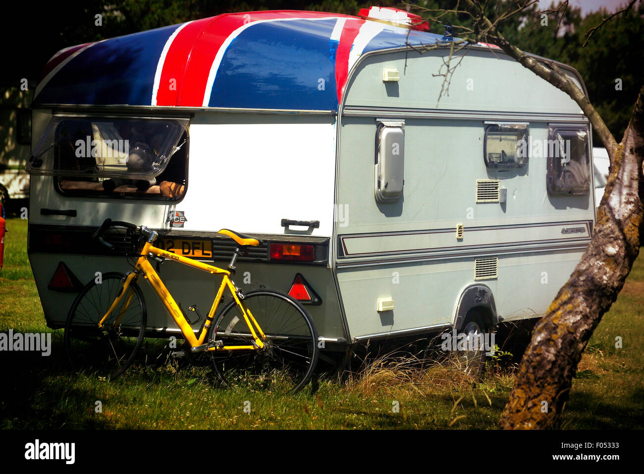 Old caravan with union jack flag painted on roof Stock Photo