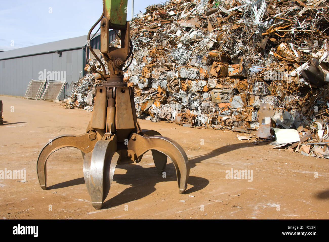Crane grabber and a hip of metal scrap Stock Photo