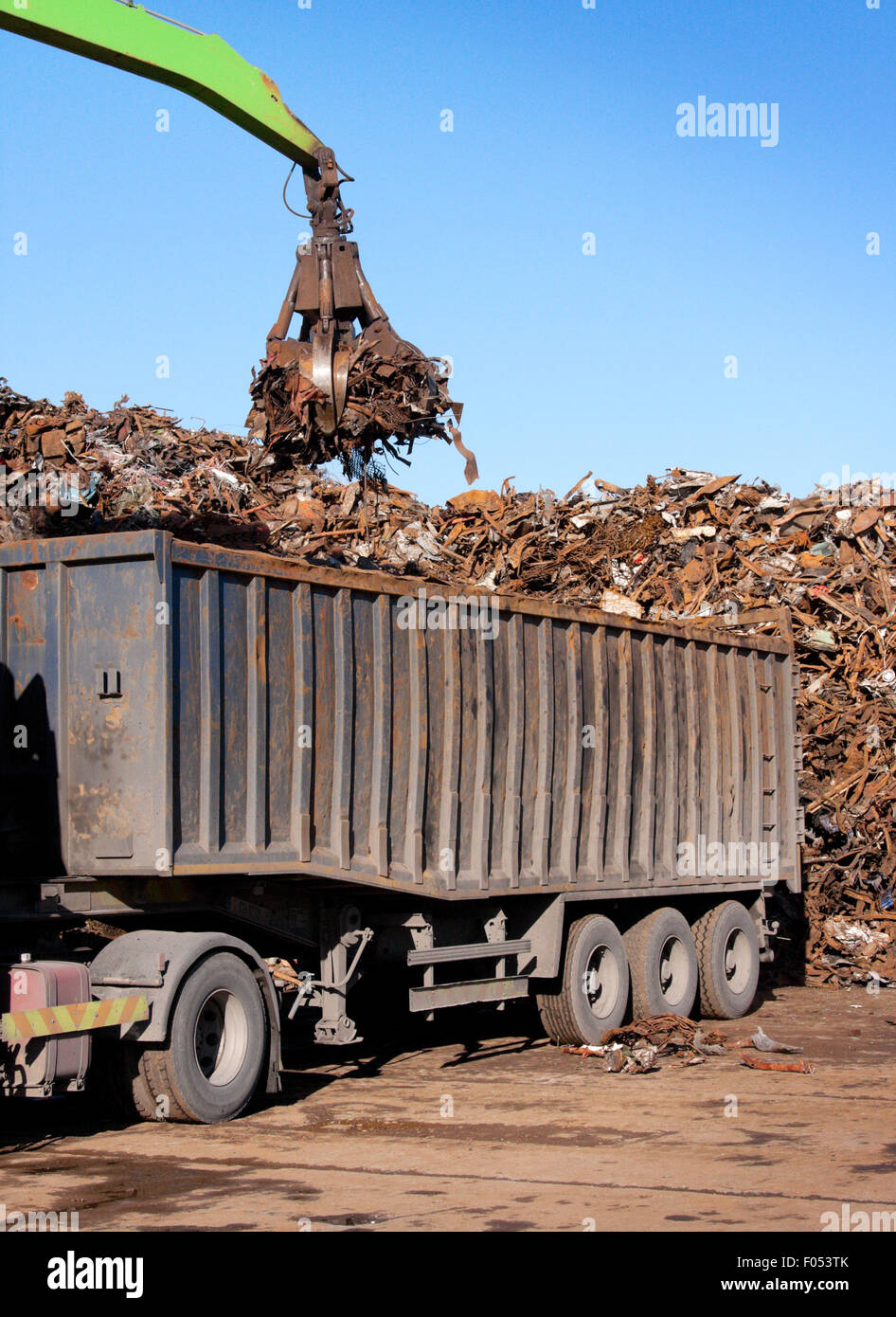 Truck loading with metal rusty scrap in the dock Stock Photo