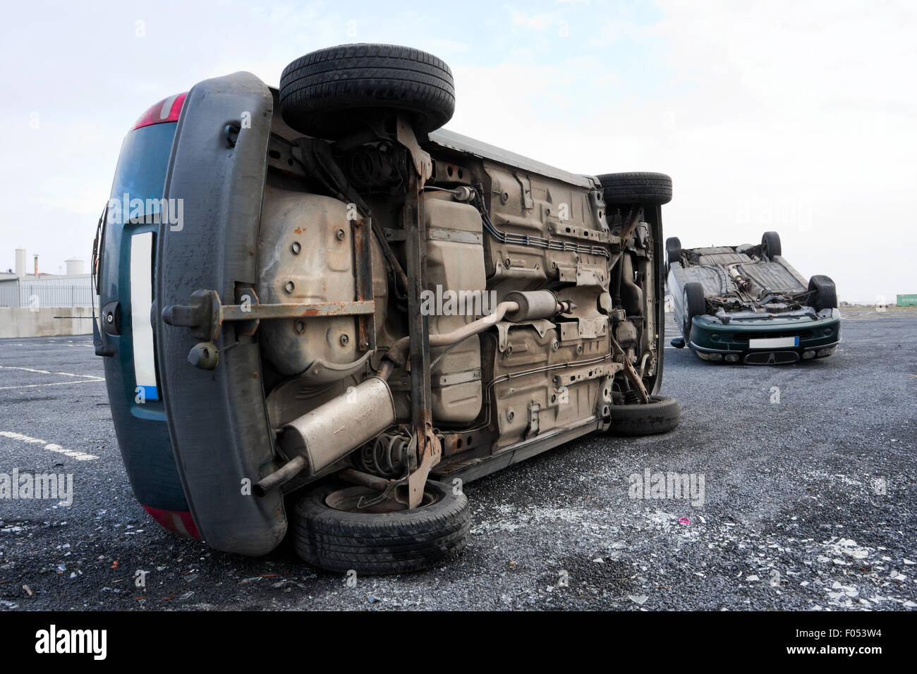 two cars turned upside-down after road collision Stock Photo