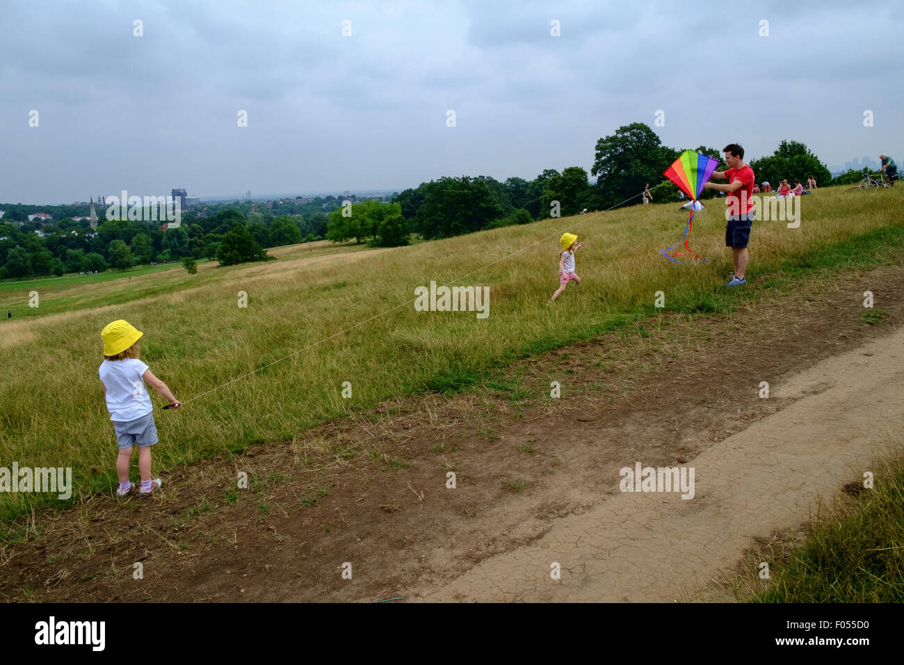family flying kite hampstead heath father children dad kid kids Stock Photo