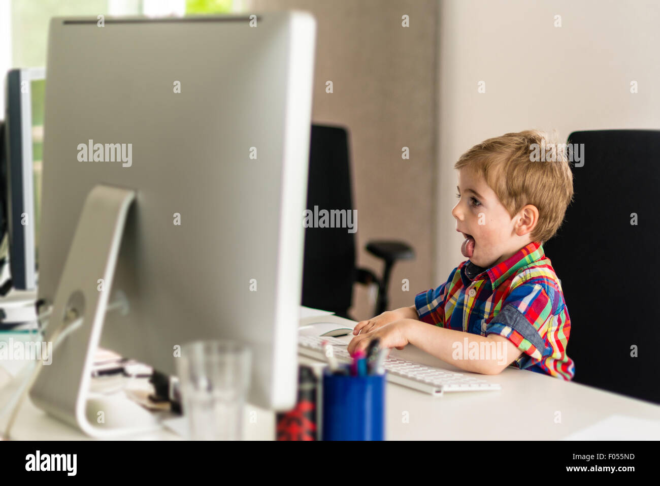 Little boy plays with computer Stock Photo - Alamy