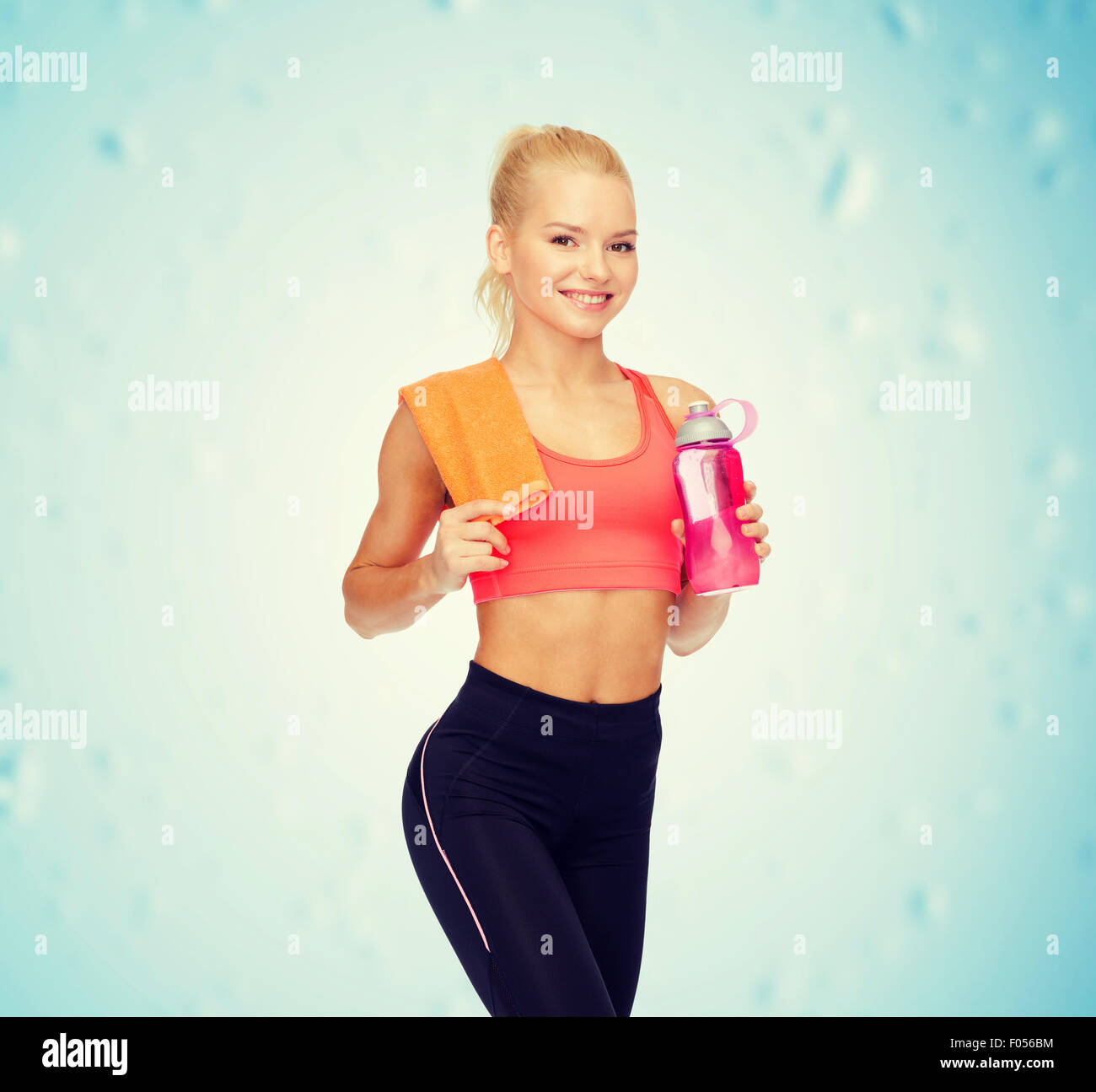 smiling sporty woman with water bottle and towel Stock Photo