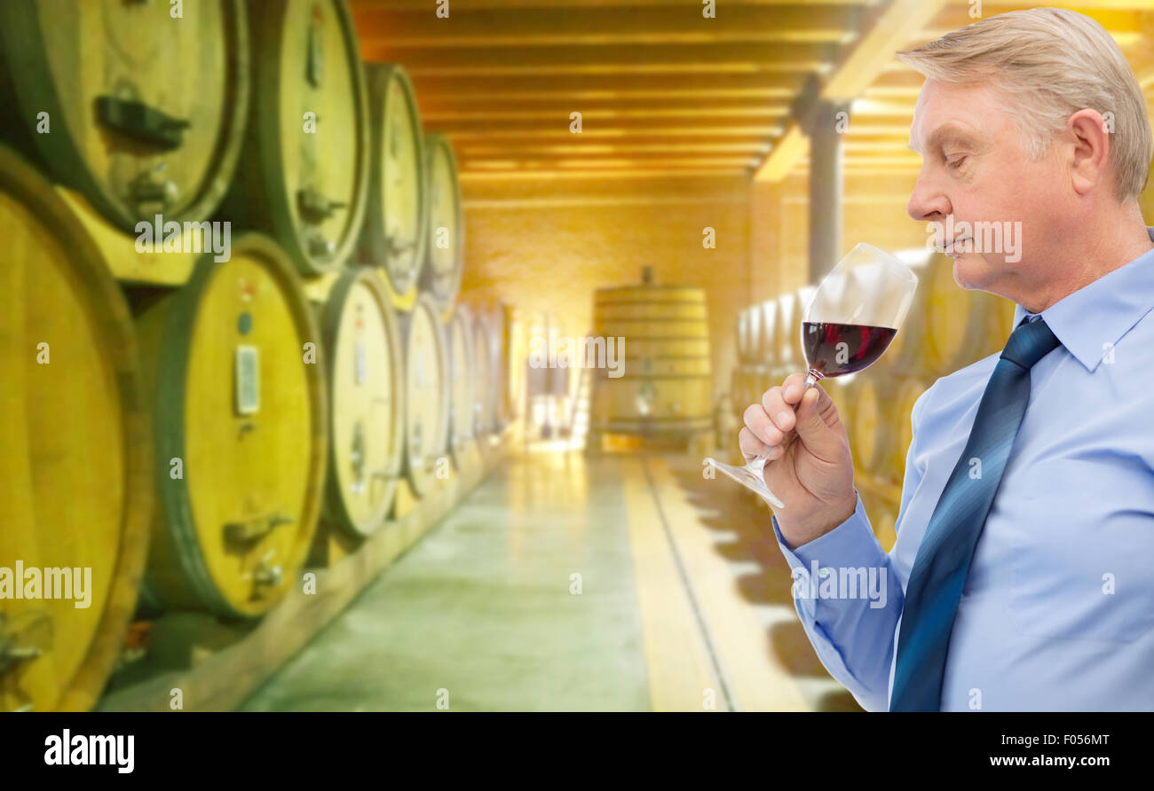senior man smelling red wine in cellar Stock Photo Alamy