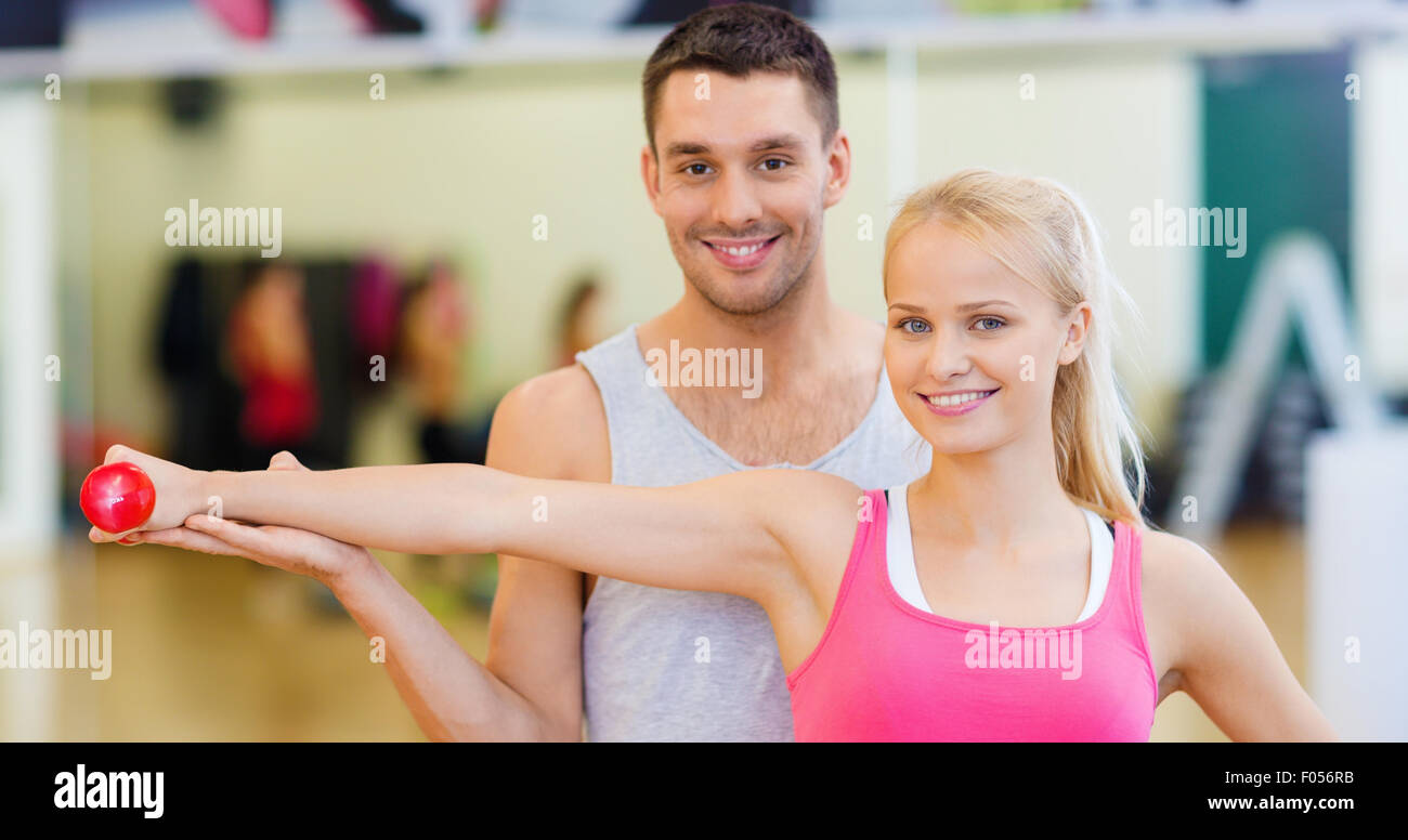 male trainer with woman working out with dumbbell Stock Photo - Alamy
