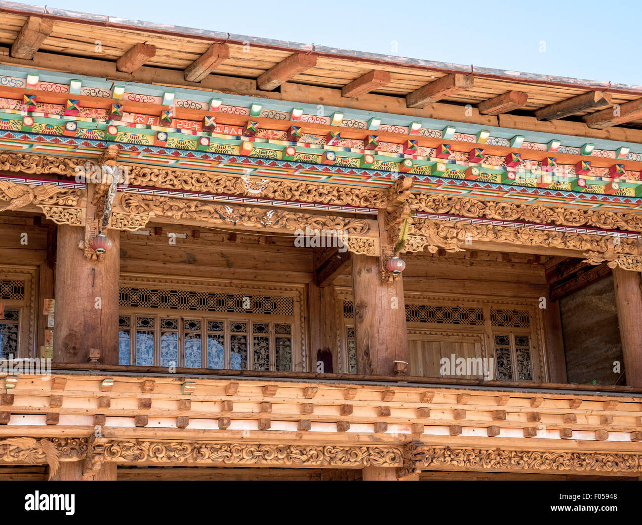 The Wood Carving On A Traditional Tibetan Style Farmhouse In The Yunnan Province Of China Near Shangri-La Stock Photo