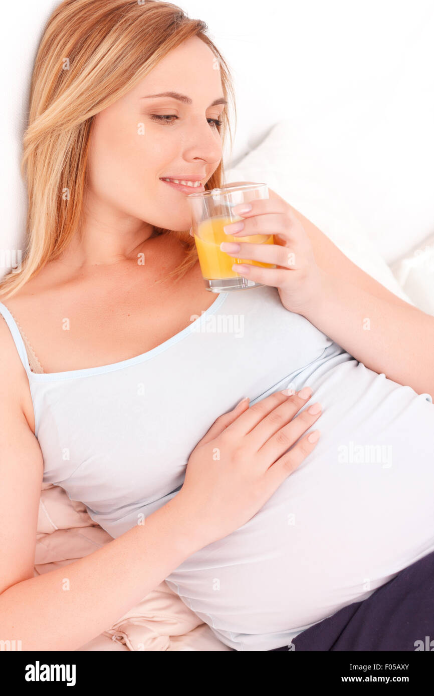Pregnant woman drinking orange juice Stock Photo Alamy