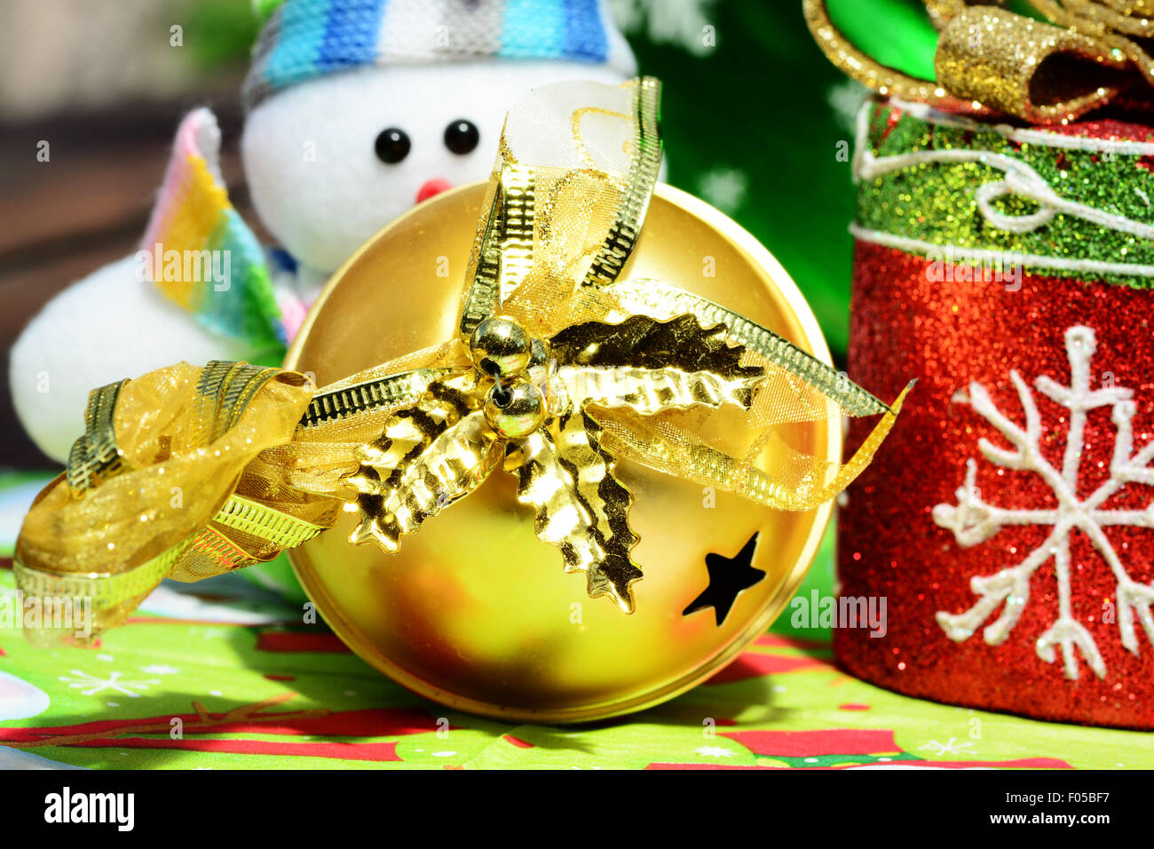 Macro shot of a golden christmas ball and other decorations Stock Photo