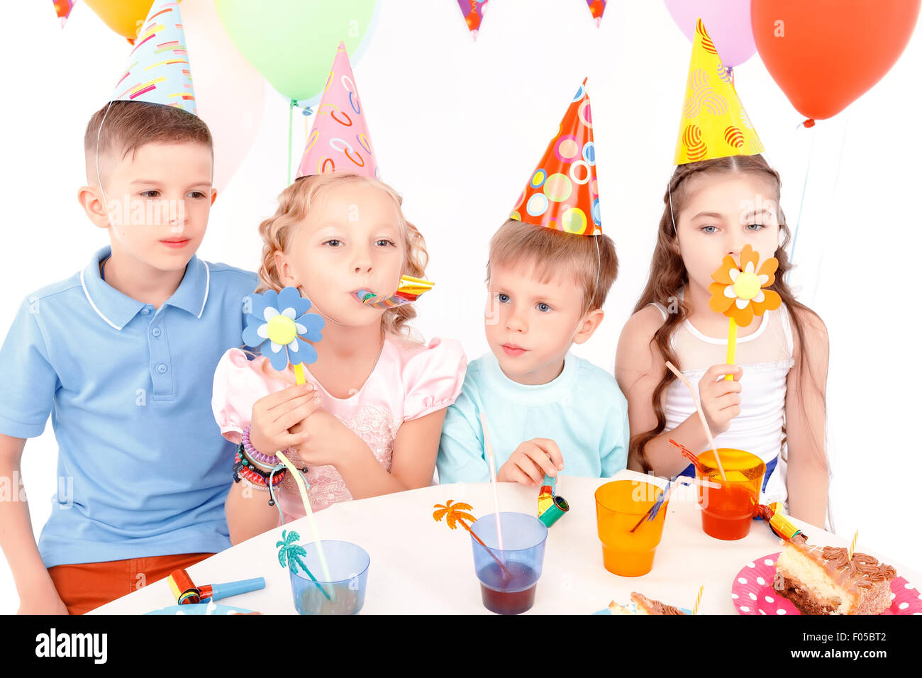 Children posing with birthday party equipment Stock Photo Alamy