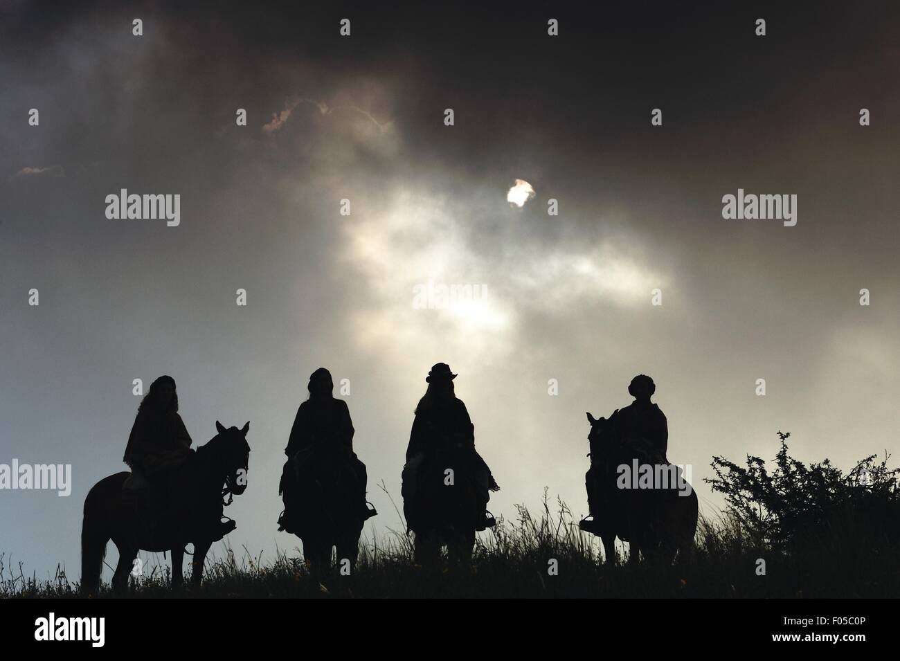 Silhoutte of horse riders on adventure holiday at Estancia Los Potreros, Cordoba, Argentina Stock Photo