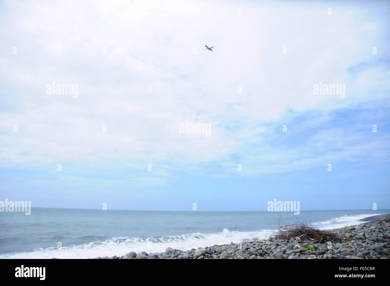 La Reunion. 7th Aug, 2015. An aircraft searching for MH370 debris flies over the Saint Andre beach, northeast of France's oversea island La Reunion. Authority of France's oversea island La Reunion has confirmed the plan of search for more MH370 parts and said the search will last for at least one week. Credit:  Zhang Chuanshi/Xinhua/Alamy Live News Stock Photo
