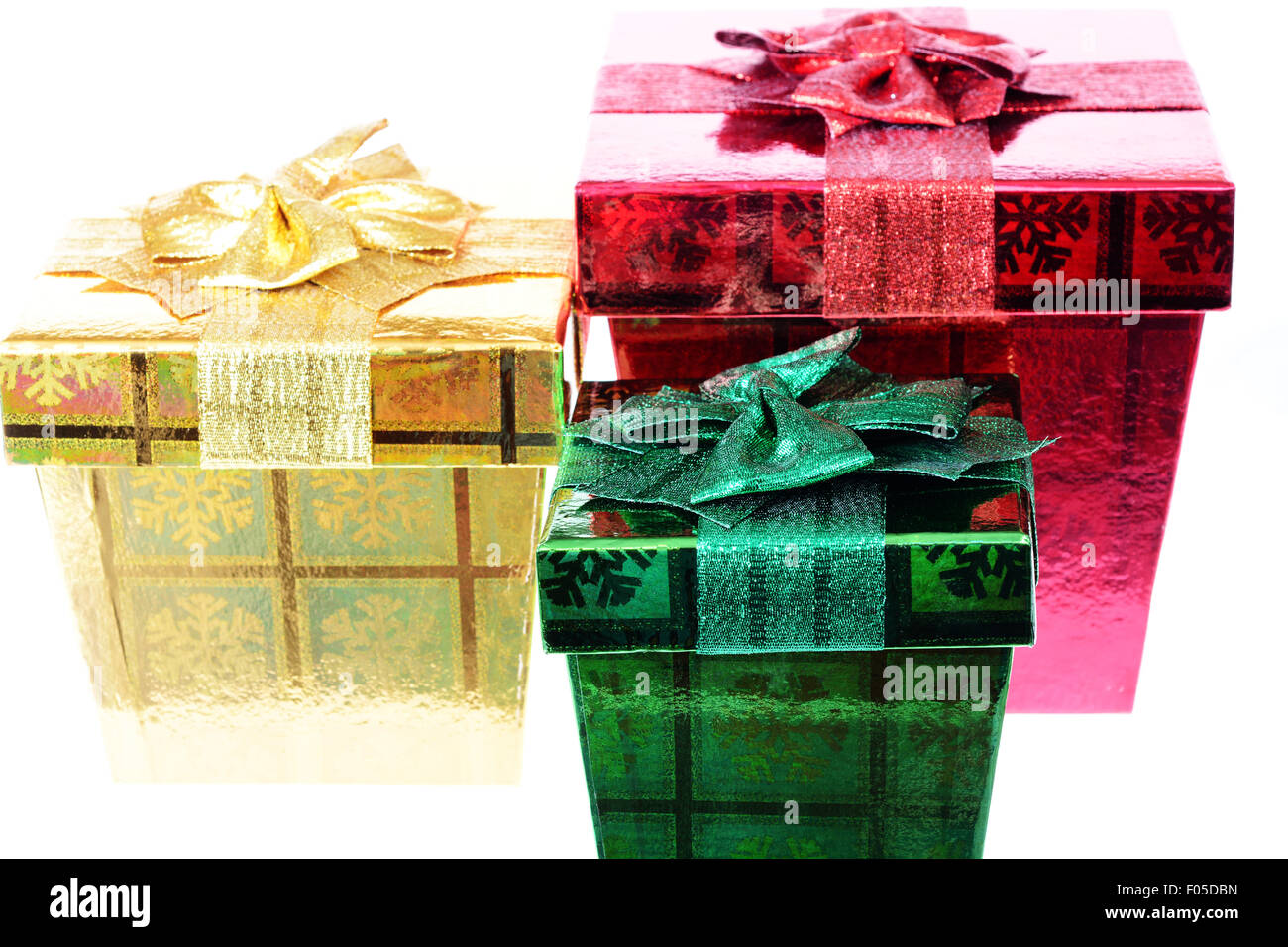 Three gift boxes of different size and color isolated on white Stock