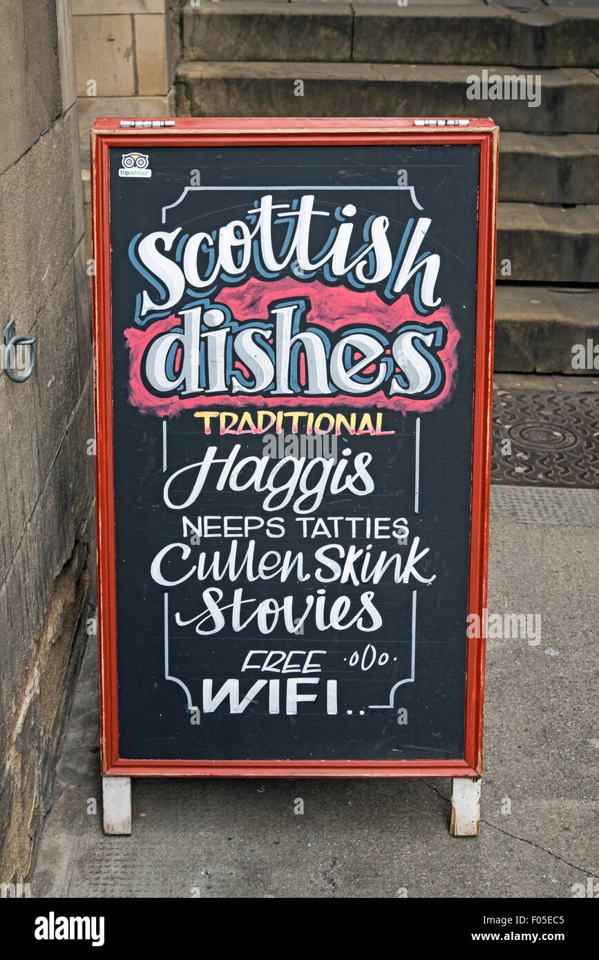 An a-board in the Old Town of Edinburgh advertising Traditional Scottish dishes. Stock Photo