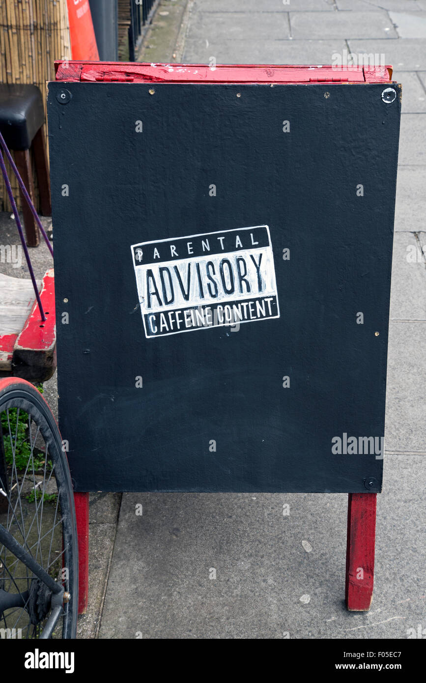 A-board advert outside 'Artisan Roast' in Broughton Street, Edinburgh featuring a Parental Advisory - Caffeine Content warning. Stock Photo