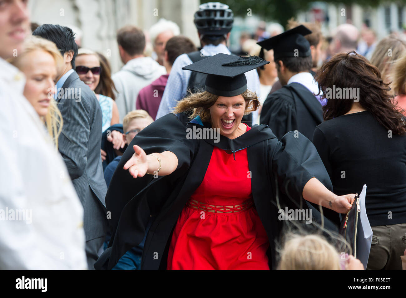 A student mum from Brighton celebrates graduating near the Brighton Pavilion with family and friends. Stock Photo
