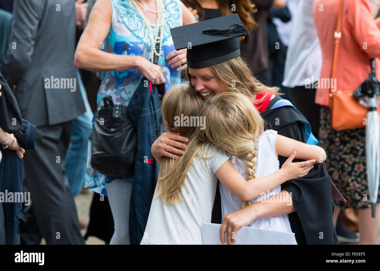 A student mum from Brighton celebrates graduating near the Brighton Pavilion with family and friends. Stock Photo