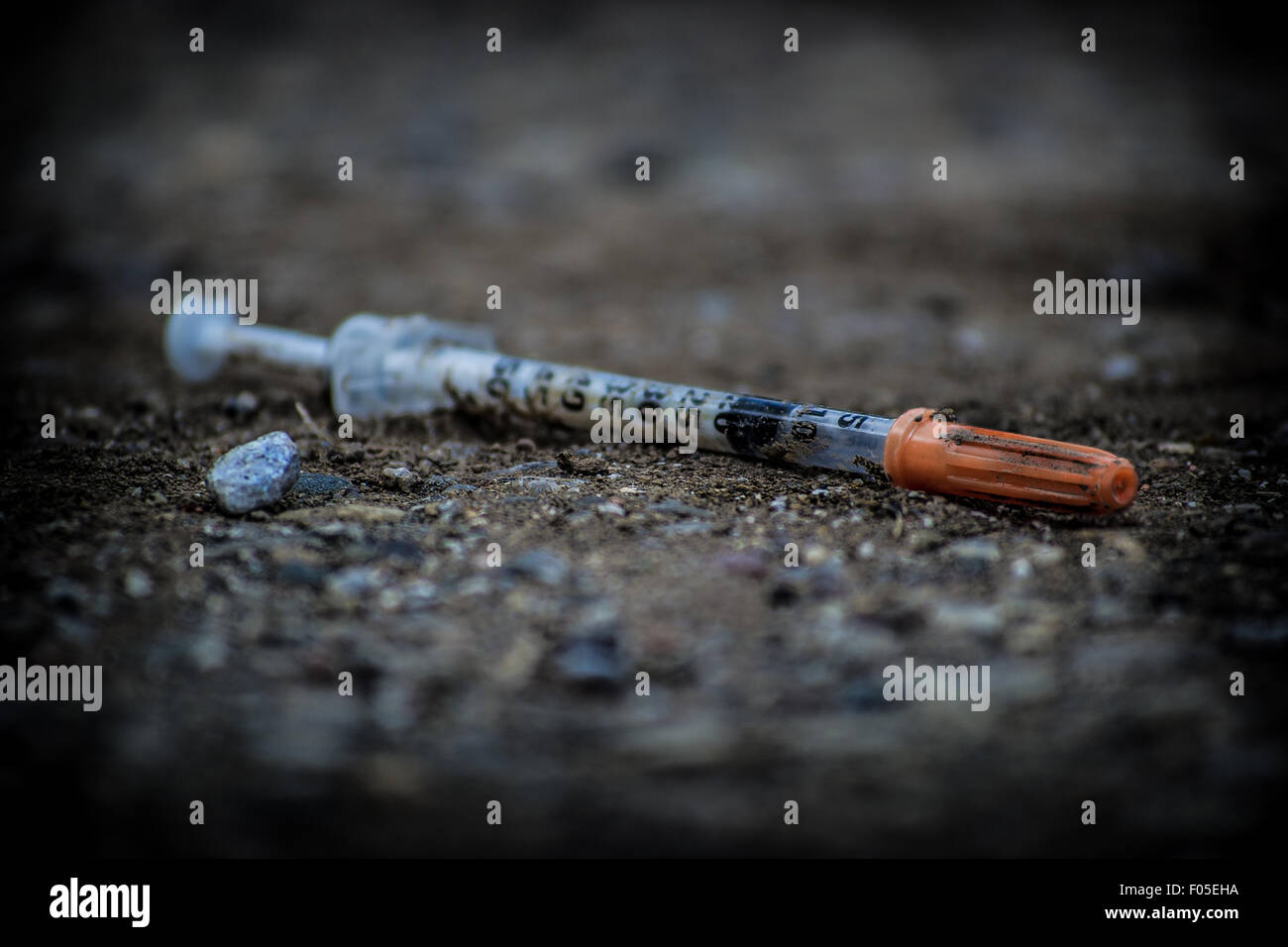 used needle near a playground Stock Photo