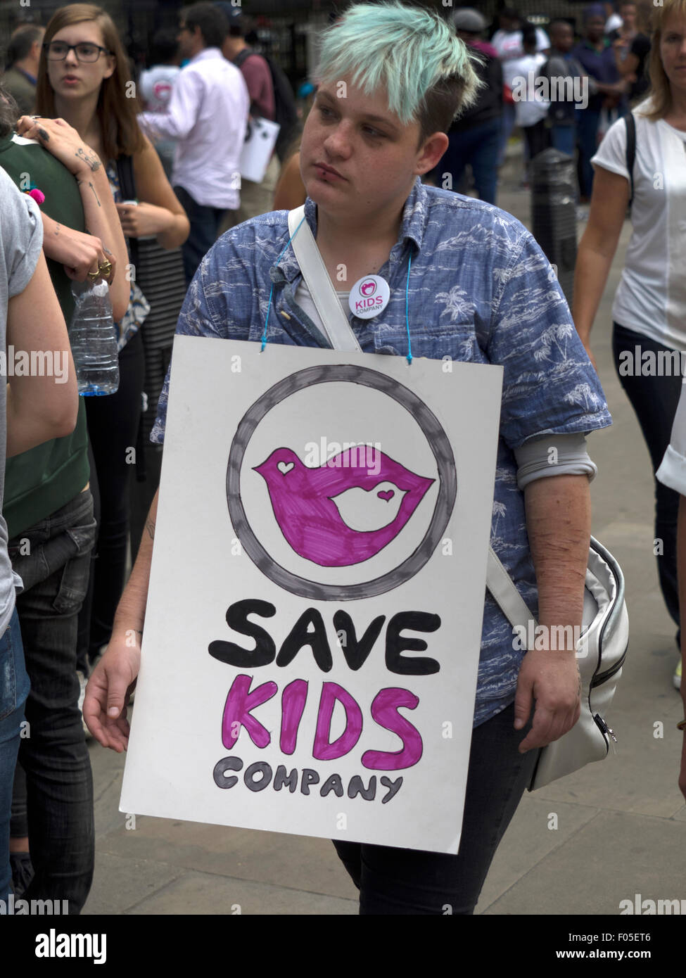 Whitehall, London, UK, 7 August 2015. A protester taking part in a demonstration opposite Downing Street aimed at saving Kids Company parades a placard. Credit:  Richard Slater/Alamy Live News Stock Photo