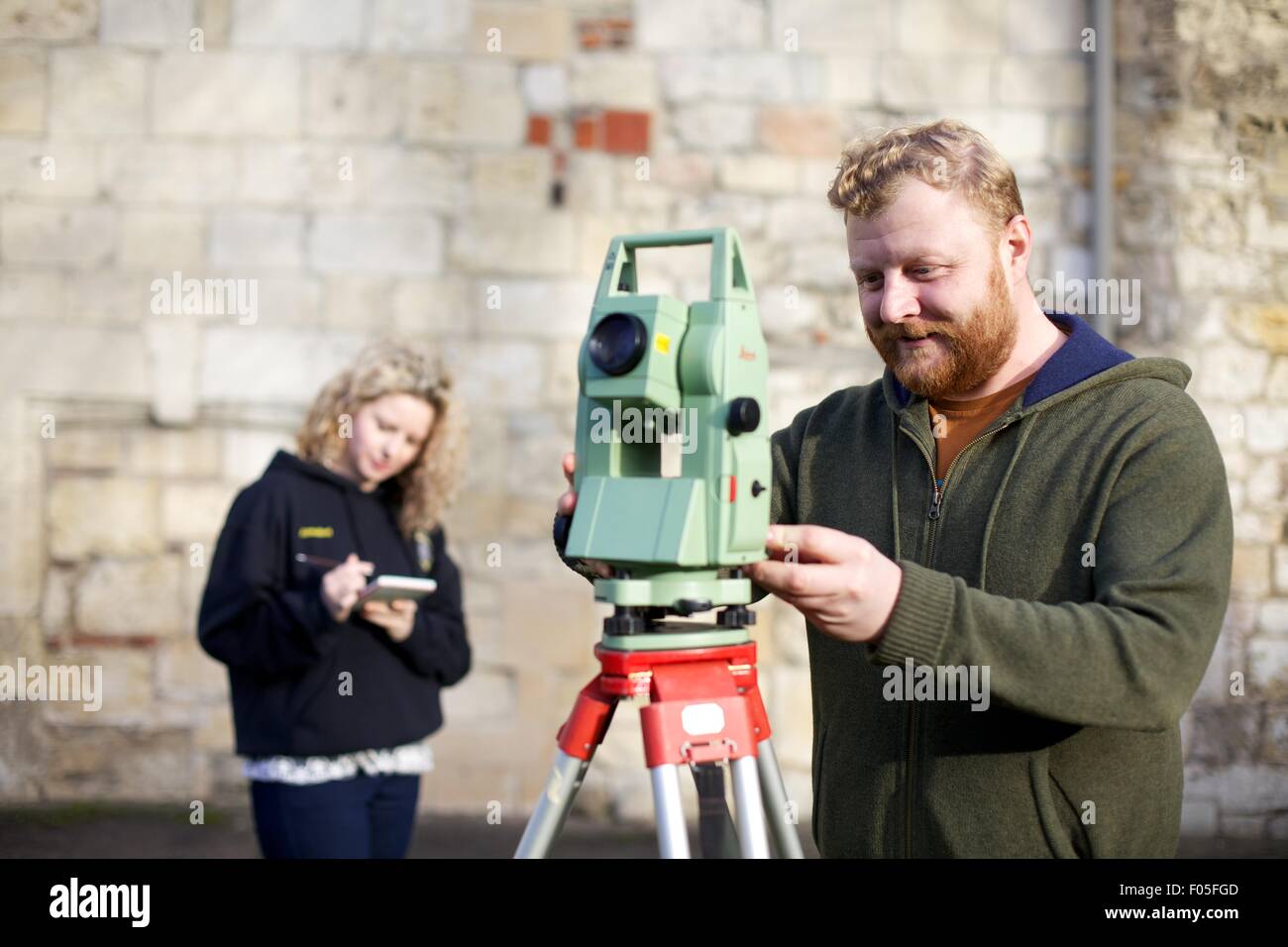 archaeology students with mapping device Stock Photo