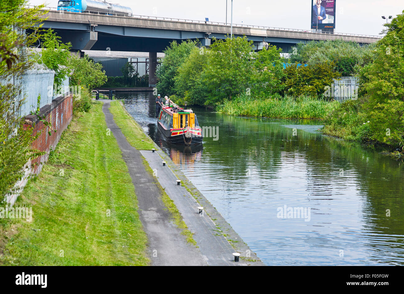 Canal boat under the M5 motorway heading up to the pools at Titford Stock Photo