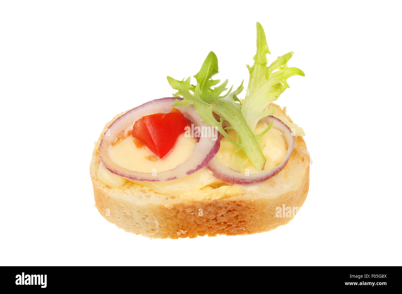 Canape, brie cheese, red onion, tomato and lettuce on French bread isolated against white Stock Photo
