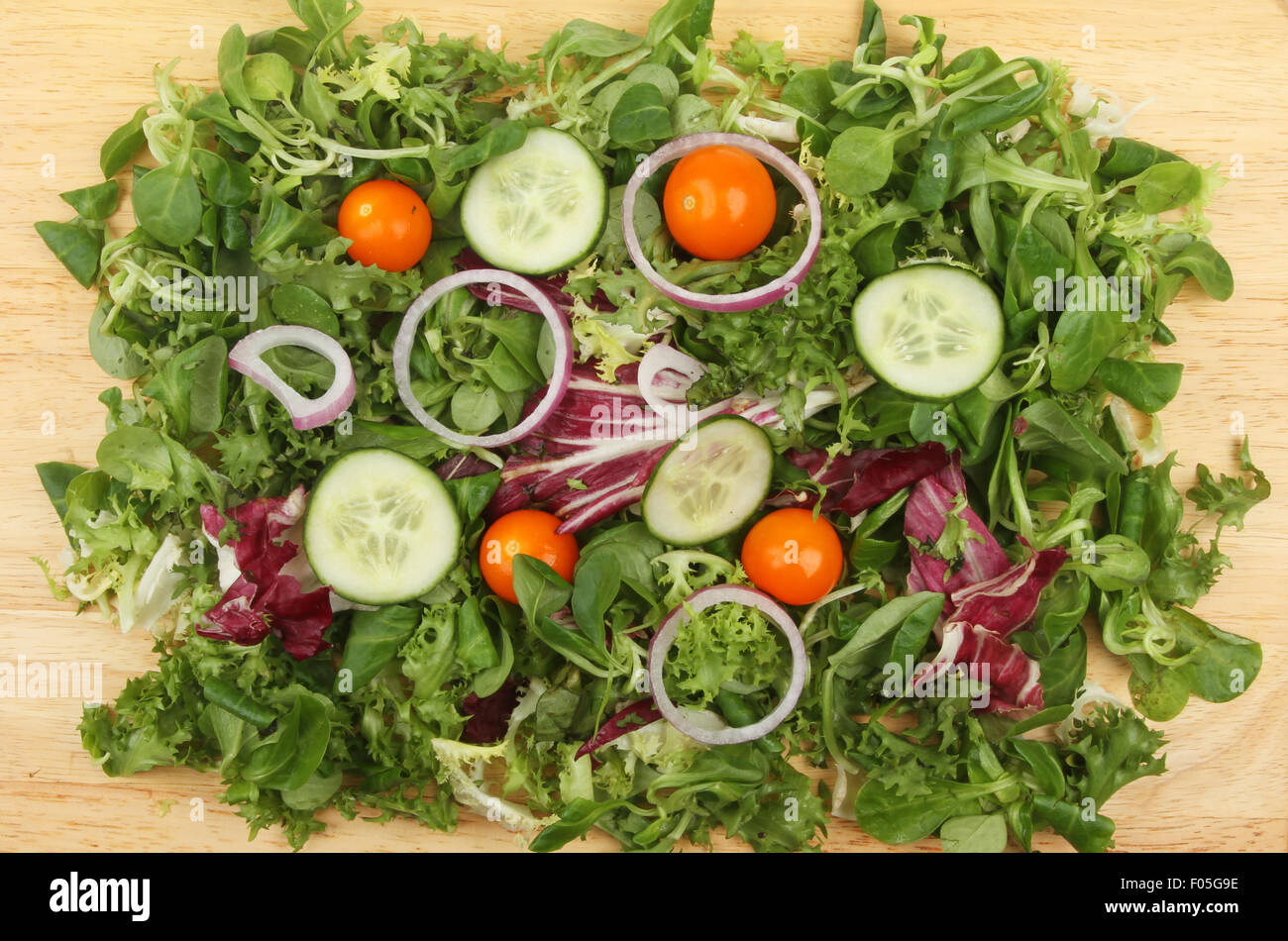Mixed salad on a wooden board viewed from above Stock Photo