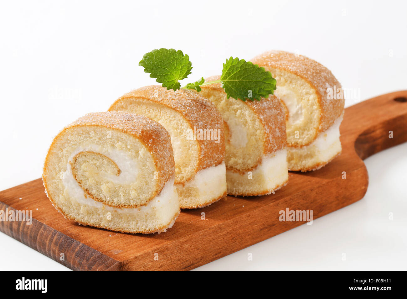 Sponge cake roll with cream filling Stock Photo Alamy