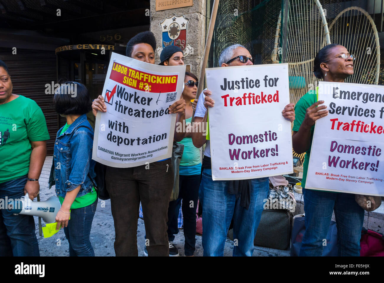 New York City, USA, Woman Holding Protest Signs, Labor Slavery Demonstration, Migrants, Filipino Domestic Workers protesters, International Immigrants rights, social justice slogans, Human Trafficking, immigrant labor, workers rights protests, peaceful protest sign Stock Photo