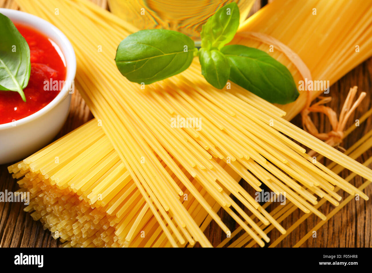Dried spaghetti and tomato passata Stock Photo