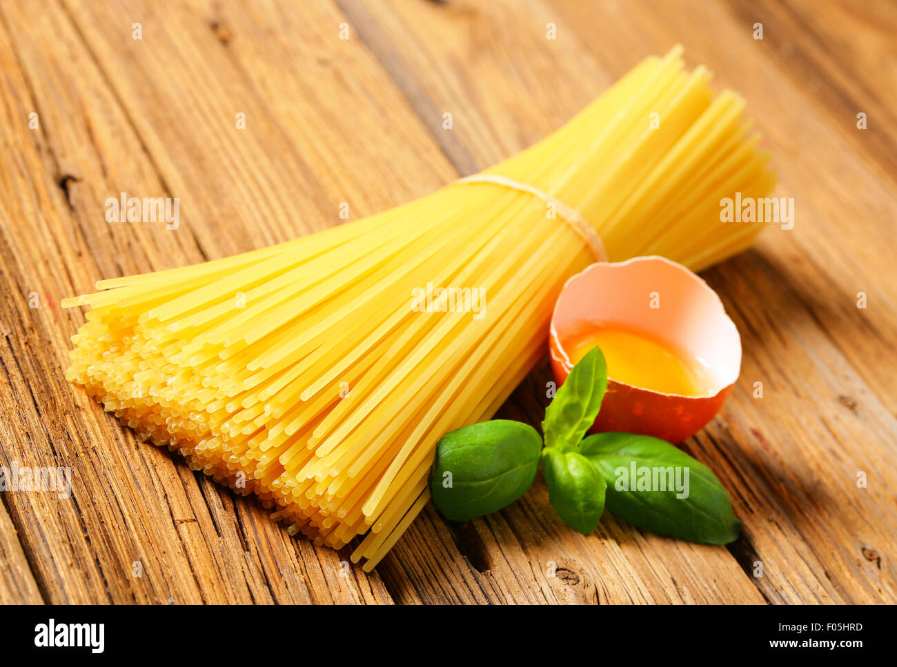 Bundle of spaghetti and raw egg Stock Photo