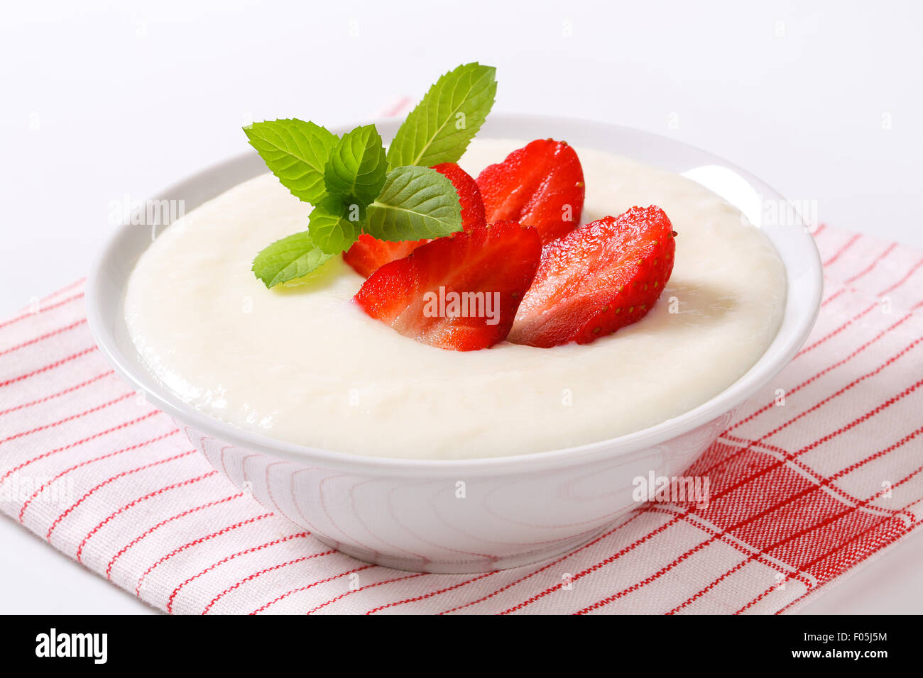 Bowl of semolina pudding with fresh strawberries Stock Photo