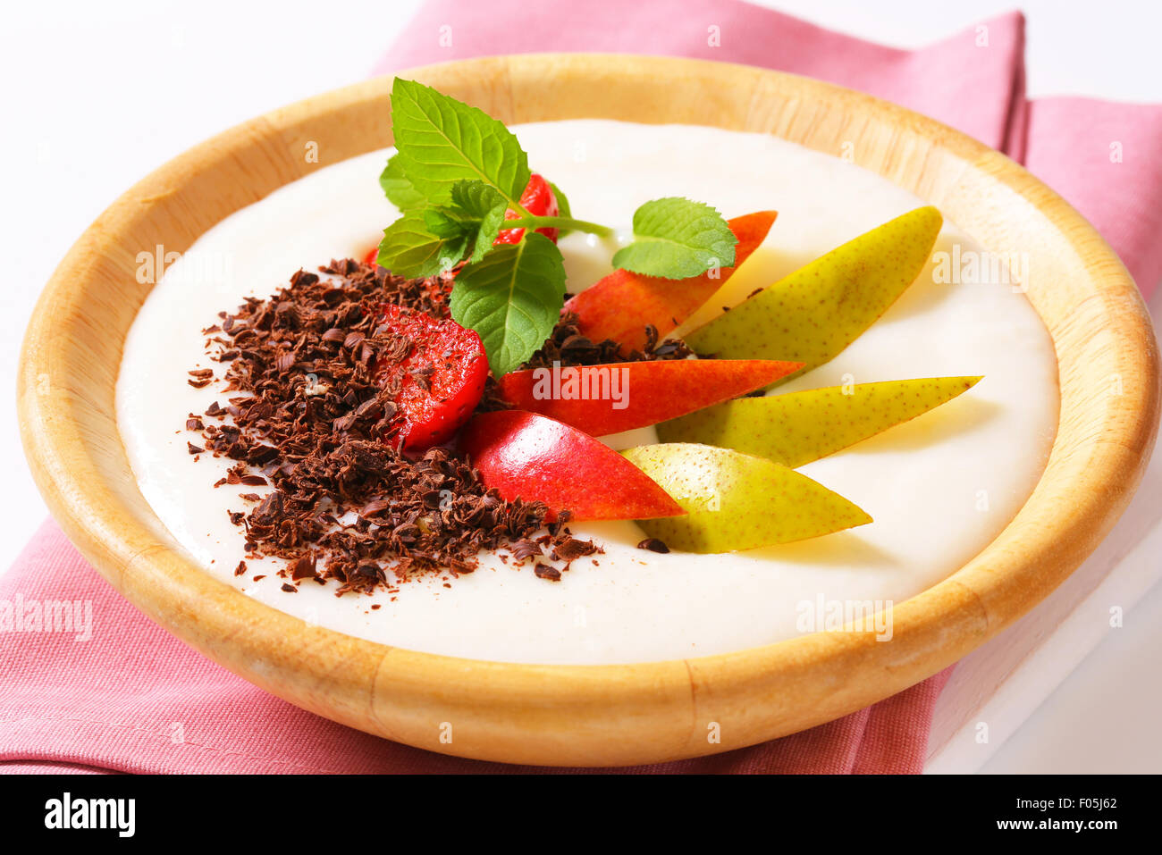 Semolina pudding served with fresh fruit and grated chocolate Stock
