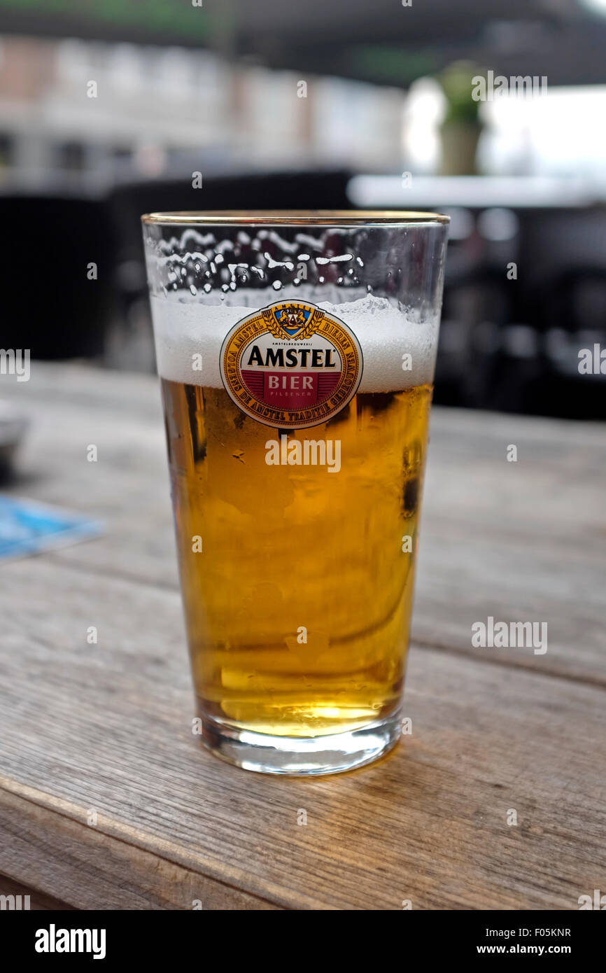 Glass of Amstel pilsner lager on a table in The Netherlands Stock Photo