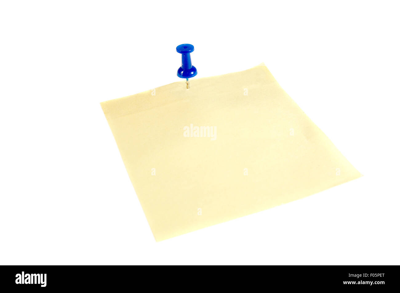 Close up of a yellow paper tag with a blue thumb tack isolated on white Stock Photo