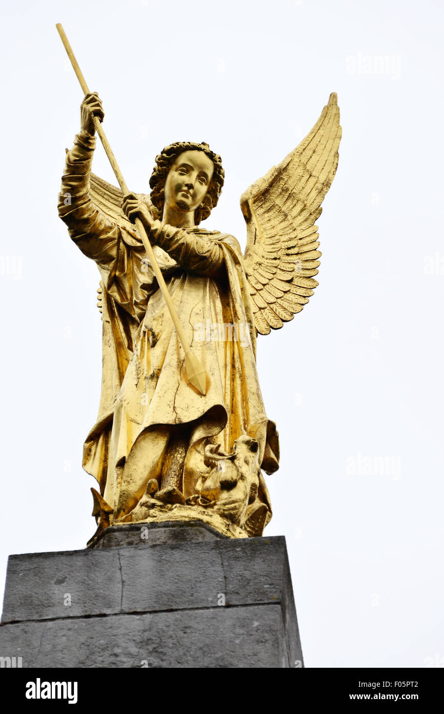 Golden Angel statue with a spear in its hands Stock Photo