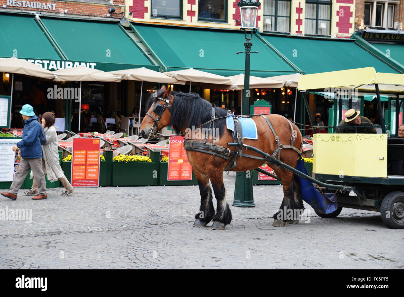 Horse cart in the market square in Bruges, Belgium. Stock Photo